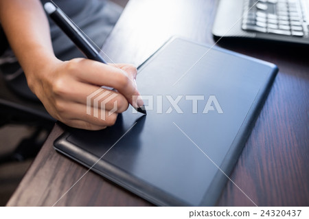 Woman using a pc tablet Woman using a pc tablet 24320437