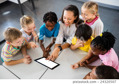 Happy teacher and pupils using tablet pc 24320507