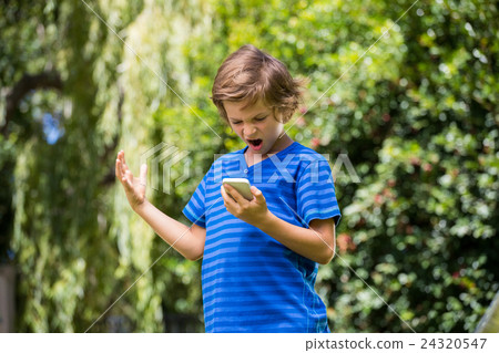 A little boy is angry with his mobile phone A little boy is angry with his mobile phone 24320547