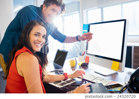 Colleagues using a graphic pad Colleagues using a graphic pad 24320720