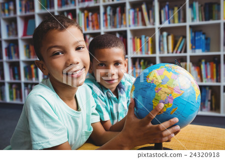 Boys studying the globe 24320918