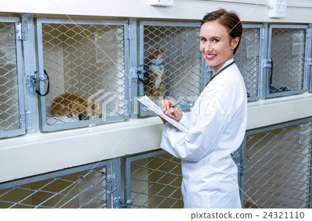 A woman vet smiling and taking notes 24321110