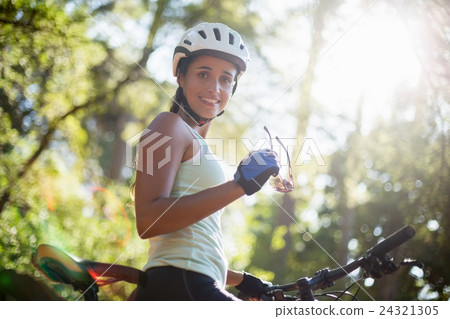 Woman smiling and posing with her bike 24321305