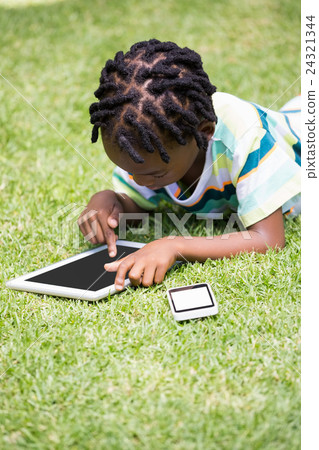 A kid playing with a tablet computer A kid playing with a tablet computer 24321344