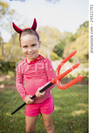 Portrait of cute girl smiling and pretending to be a devil Portrait of cute girl smiling and pretending to be a devil 24321701