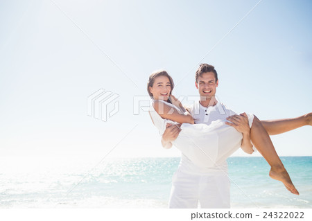 Handsome man holding his girlfriend Handsome man holding his girlfriend 24322022