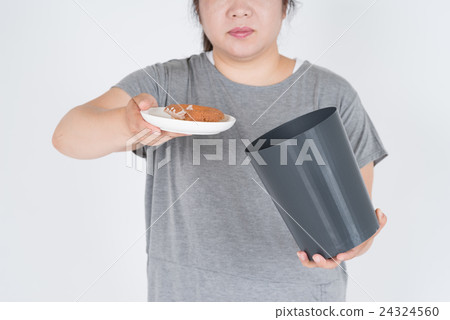 A fat woman who throws away a donut in a garbage can 24324560