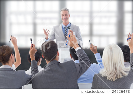 Composite image of business people raising their arms during meeting 24326478
