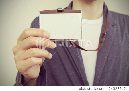 Casual businessman showing employee ID card Casual businessman showing employee ID card 24327542