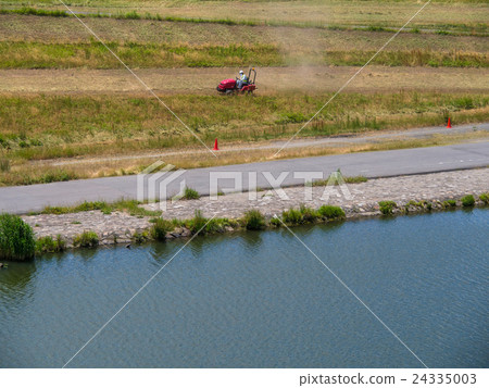 Riding mowing car cutting the levee weeds 24335003