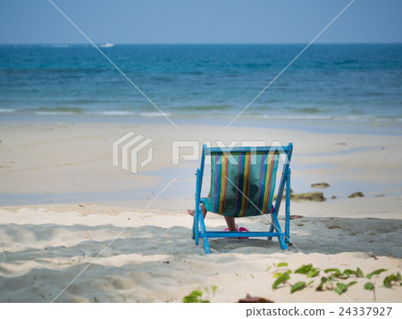 Kid sitting on beach chair Kid sitting on beach chair 24337927