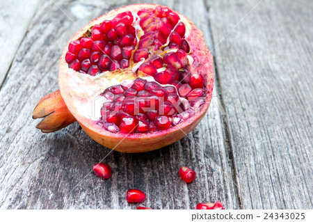 Juicy pomegranates on wood Juicy pomegranates on wood 24343025