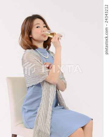 A young woman drinking champagne 24343212