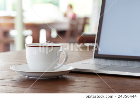 Cup of coffee and laptop Cup of coffee and laptop 24350444