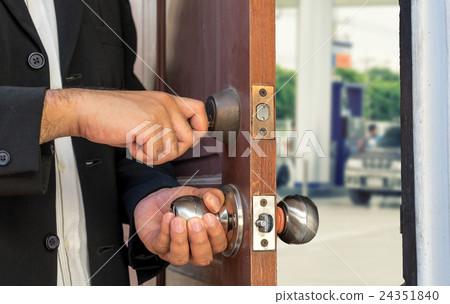 businessman open the door on blur gas station view businessman open the door on blur gas station view 24351840