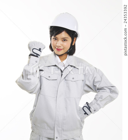 A woman who poses a guts pose in work clothes A woman who poses a guts pose in work clothes 24353392