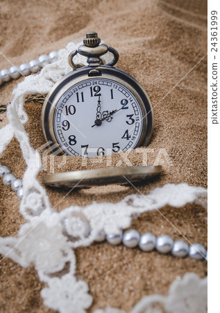 Vintage pocket watch on sand background 24361999