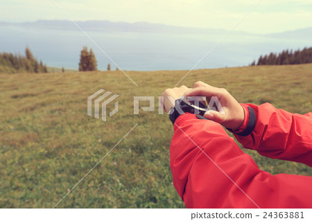 hiker checking the altimeter on sports watch  24363881
