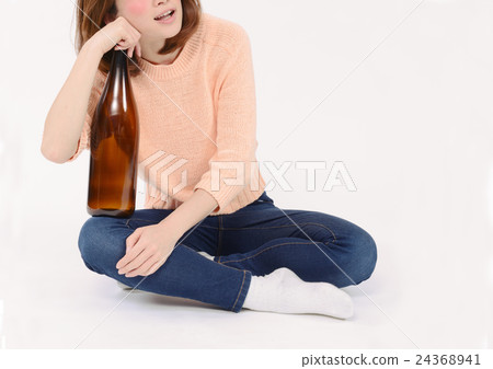 A drunken young lady holding one bottle A drunken young lady holding one bottle 24368941