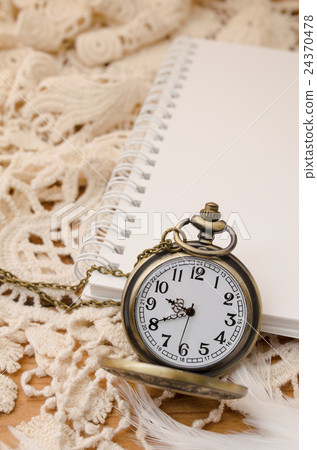 Vintage pocket watch with blank note book on lace Vintage pocket watch with blank note book on lace 24370478