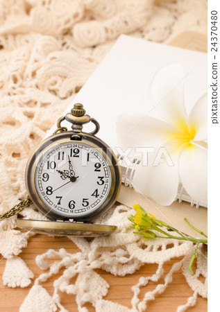 Vintage pocket watch with blank note book on lace Vintage pocket watch with blank note book on lace 24370480