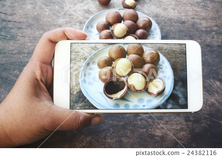 Taking a photo of macadamia nuts with smart phone 24382116