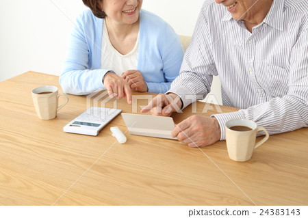 Hand of elderly couple consulting households Hand of elderly couple consulting households 24383143
