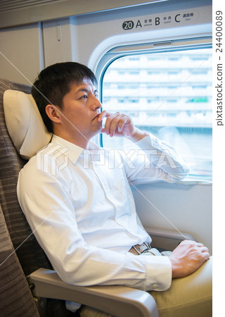 Men relaxing in the train of the bullet train 24400089