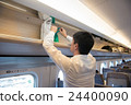 A man putting baggage in the train of a bullet train 24400090