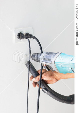 Asian Man Hand Drill On White Wall Asian Man Hand Drill On White Wall 24402165