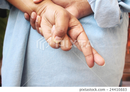 Woman crossed fingers behind back 24410883