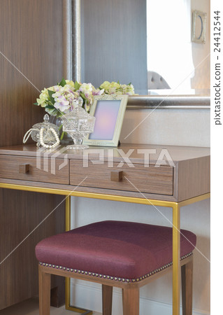 Jewery crystal jar with flowers vase on the table Jewery crystal jar with flowers vase on the table 24412544