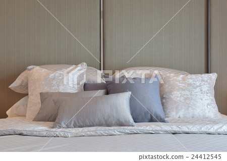 Modern bedroom with gray and striped pillow on bed Modern bedroom with gray and striped pillow on bed 24412545