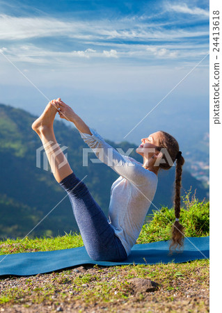 Woman doing Ashtanga Vinyasa Yoga asana outdoors 24413618