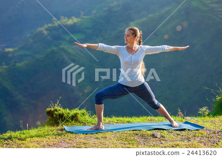 Woman doing yoga asana Virabhadrasana 2 - Warrior 24413620