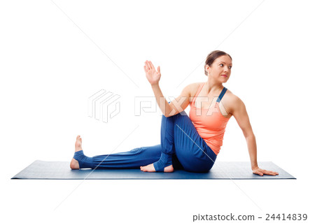 Woman doing yoga asana Ardha matsyendrasana Woman doing yoga asana Ardha matsyendrasana 24414839