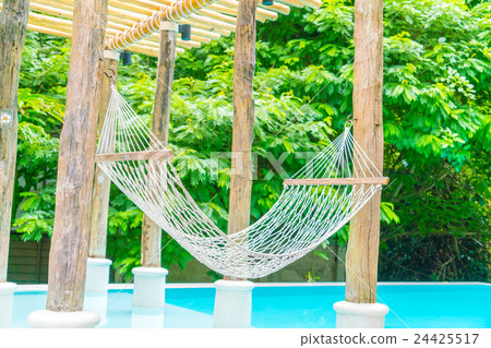 White hammocks in Luxury swimming pool . 24425517