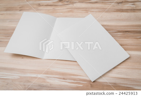 Bifold white template paper on wood texture . Bifold white template paper on wood texture . 24425913