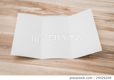 Trifold white template paper on wood texture . 24426209