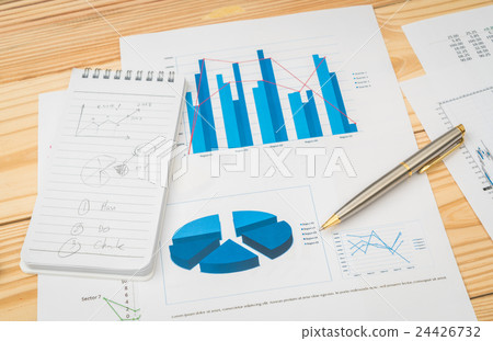 Financial charts on the table . 24426732