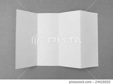 Four - fold white template paper on gray background . 24428920