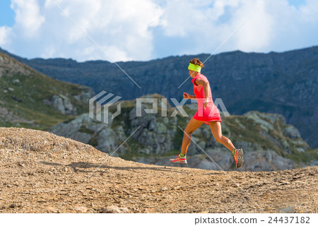 Female athlete runs in the mountains 24437182