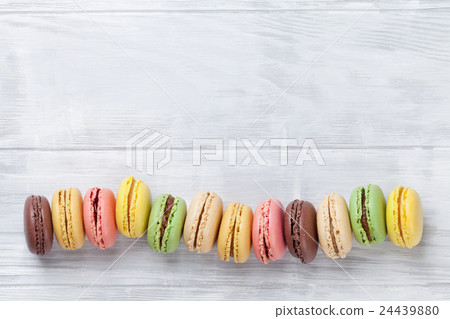 Colorful macaroons on wooden table Colorful macaroons on wooden table 24439880