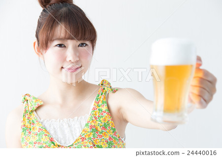 Woman drinking beer · white wall 24440016