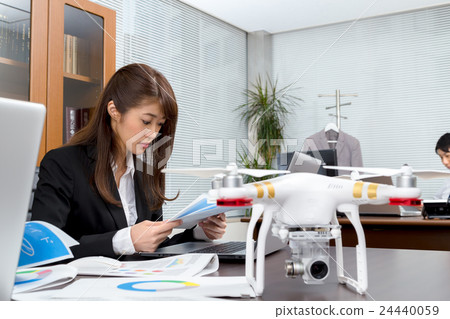 Male employee female employee drone introduction review company unmanned aerial vehicle radio control pilot aircraft quad copter 24440059