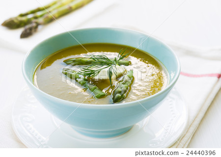 Asparagus soup in a bowl with fresh cream and dill 24440396