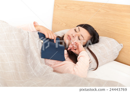 A woman reading and going to bed 24443769
