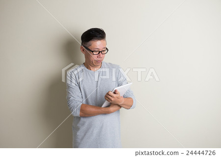 matured asian male using tablet matured asian male using tablet 24444726
