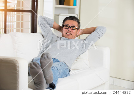 asian senior man relaxing on sofa at home asian senior man relaxing on sofa at home 24444852