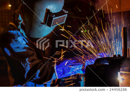 worker with protective mask welding metal 24456286